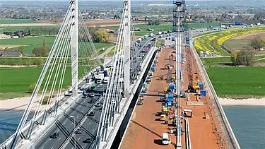 Een foto van de Brug over de Waal/Tacticusbrug, een stalen tuibrug van kokerliggers die de Waal bij Ewijk overspant